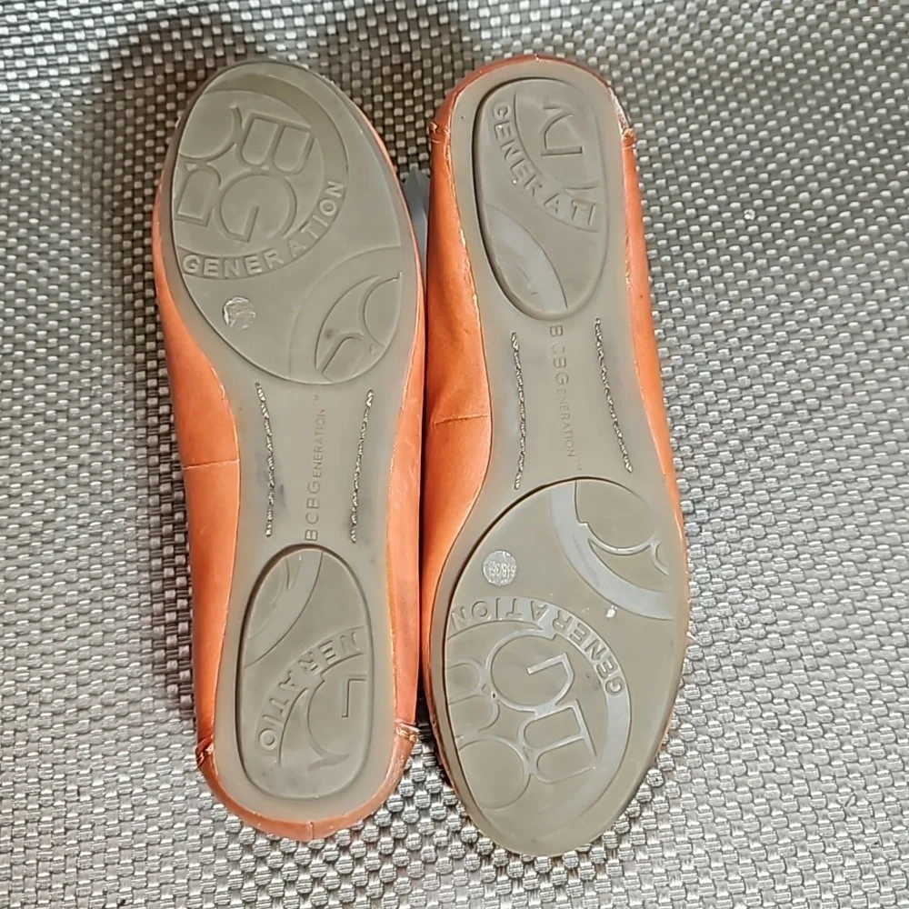 BCBG Leather Loafers.  Gold Embellishment with Coral Colored Jewel.  Size 6.5 B